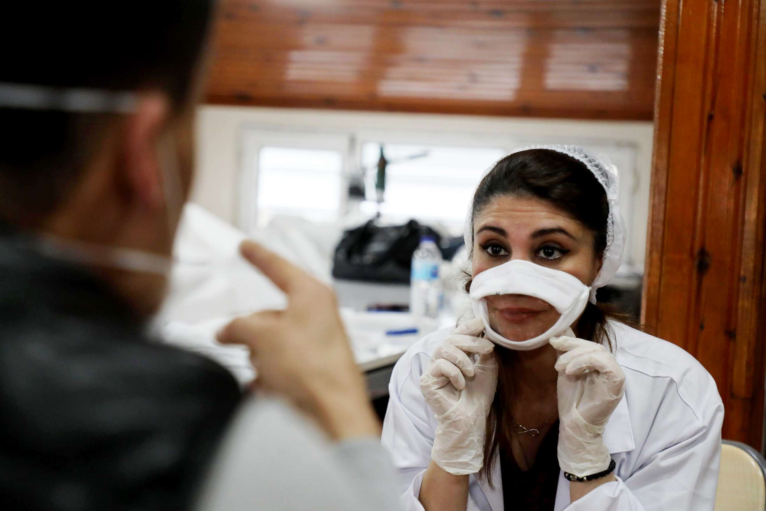 PHOTO: A medical worker wears a face mask with a transparent window to allow for lip reading while speaking with others while at work in Istanbul, May 27, 2020.