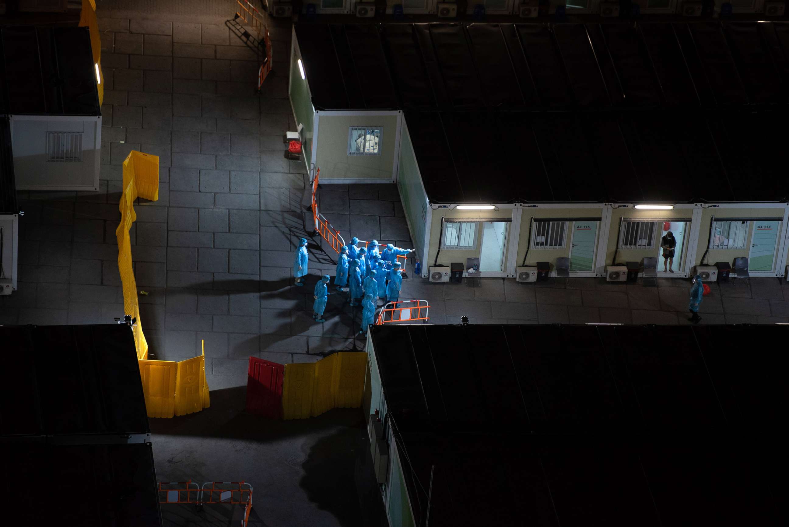 PHOTO: Health workers at a COVID-19 isolation facility, March 7, 2022, in Hong Kong, China.