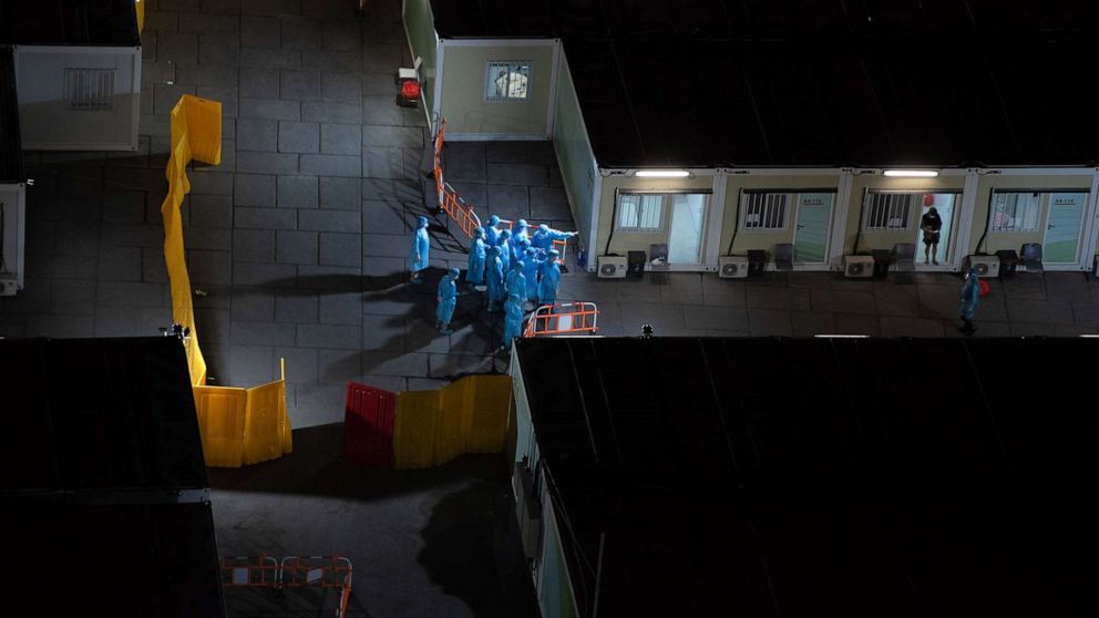 PHOTO: Health workers at a COVID-19 isolation facility, March 7, 2022, in Hong Kong, China.