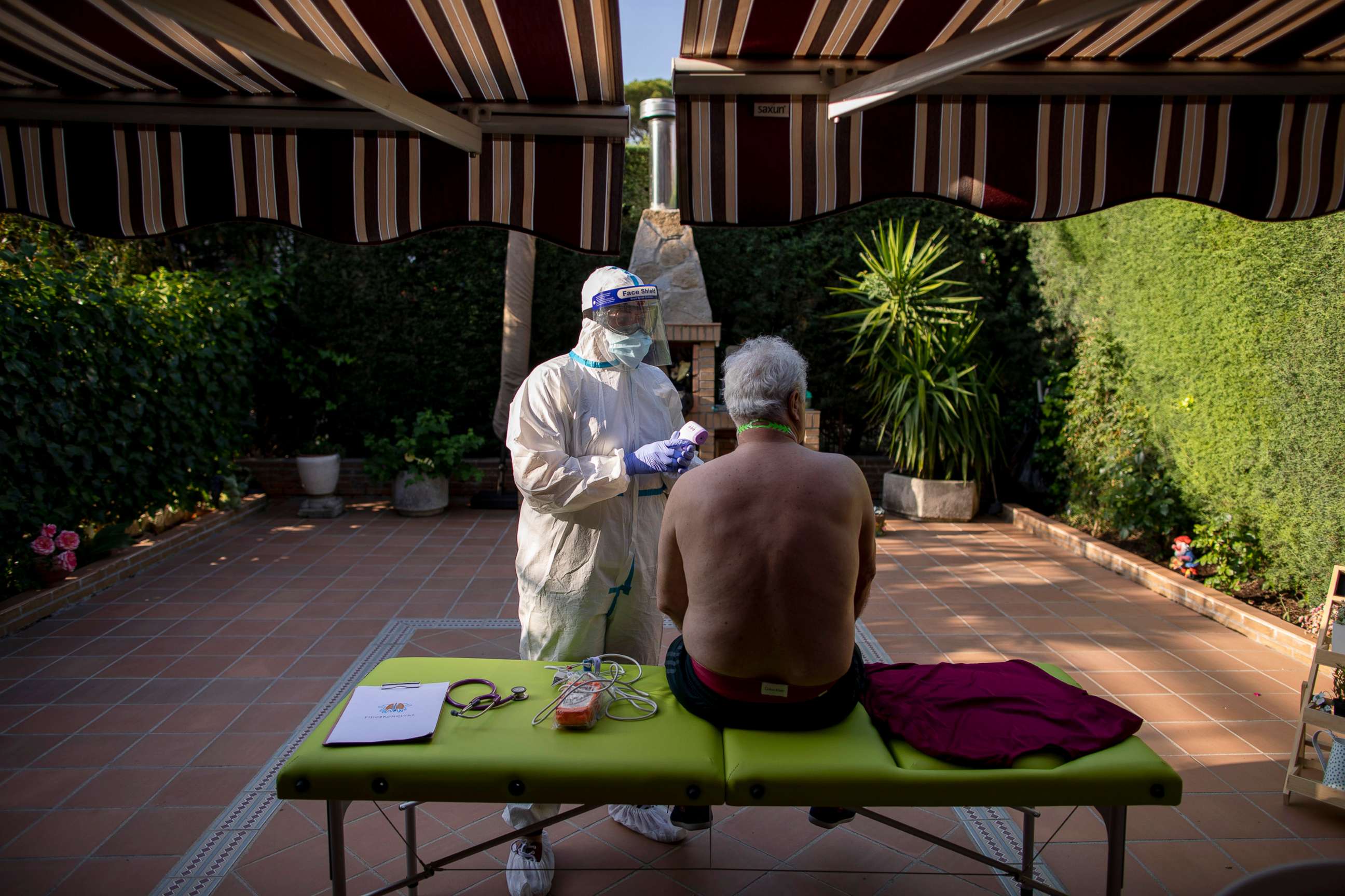 PHOTO: A physiotherapist checks on a patient experiencing breathing problems and fatigue after being released from the hospital where he was treated for Covid-19, in Madrid, June 03, 2020.