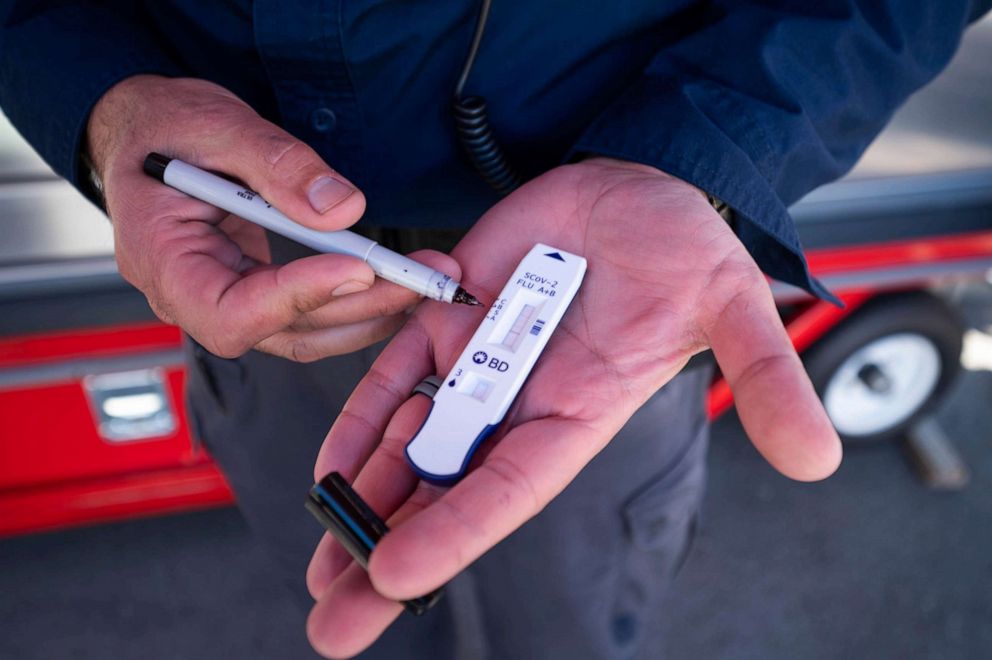 PHOTO: Steve Farzam, chief operating officer of 911 COVID Testing, shows a multiple antigen test for flu and COVID on Jan. 5, 2022 at the site near the Getty Center in Los Angeles, where a teenage boy tested positive for both the flu and COVID-19.