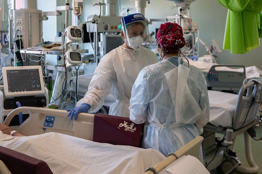 PHOTO: LODI, ITALY - FEBRUARY 11: Doctor Annalisa Malara (L), wearing PPE (Personal Protective Equipment), talks to her colleague Doctor Alessia Crespi as they stand next to a patient in the COVID-19 Intensive Care Unit of the Ospedale Maggiore di Lodi.