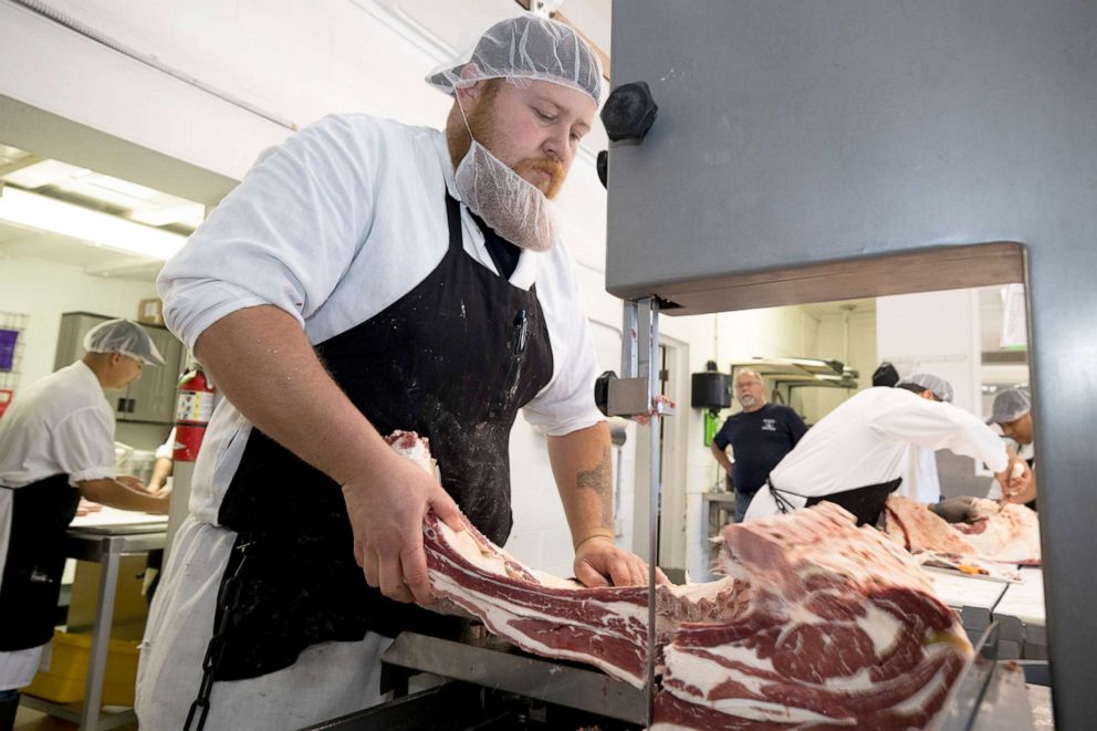 PHOTO: Butchers at Old Fashion Country Butcher process meat as they work to meet increased demand due to COVID-19 related shortages on May 21, 2020 in Santa Paula, Calif. The separation of work stations means fewer people on production lines.
