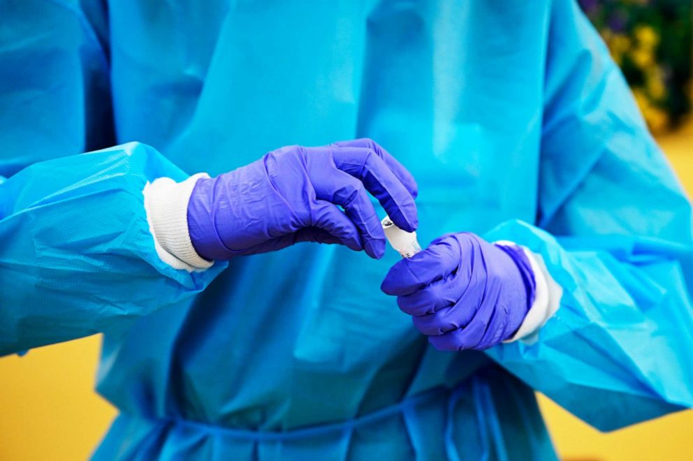 PHOTO: Medical assistant Cierra Townsley secures a sample from a client at PCR COVID-19 testing site of Kaiser Permanente Arapahoe Medical Offices in Centennial, Colo., Feb. 4, 2022.