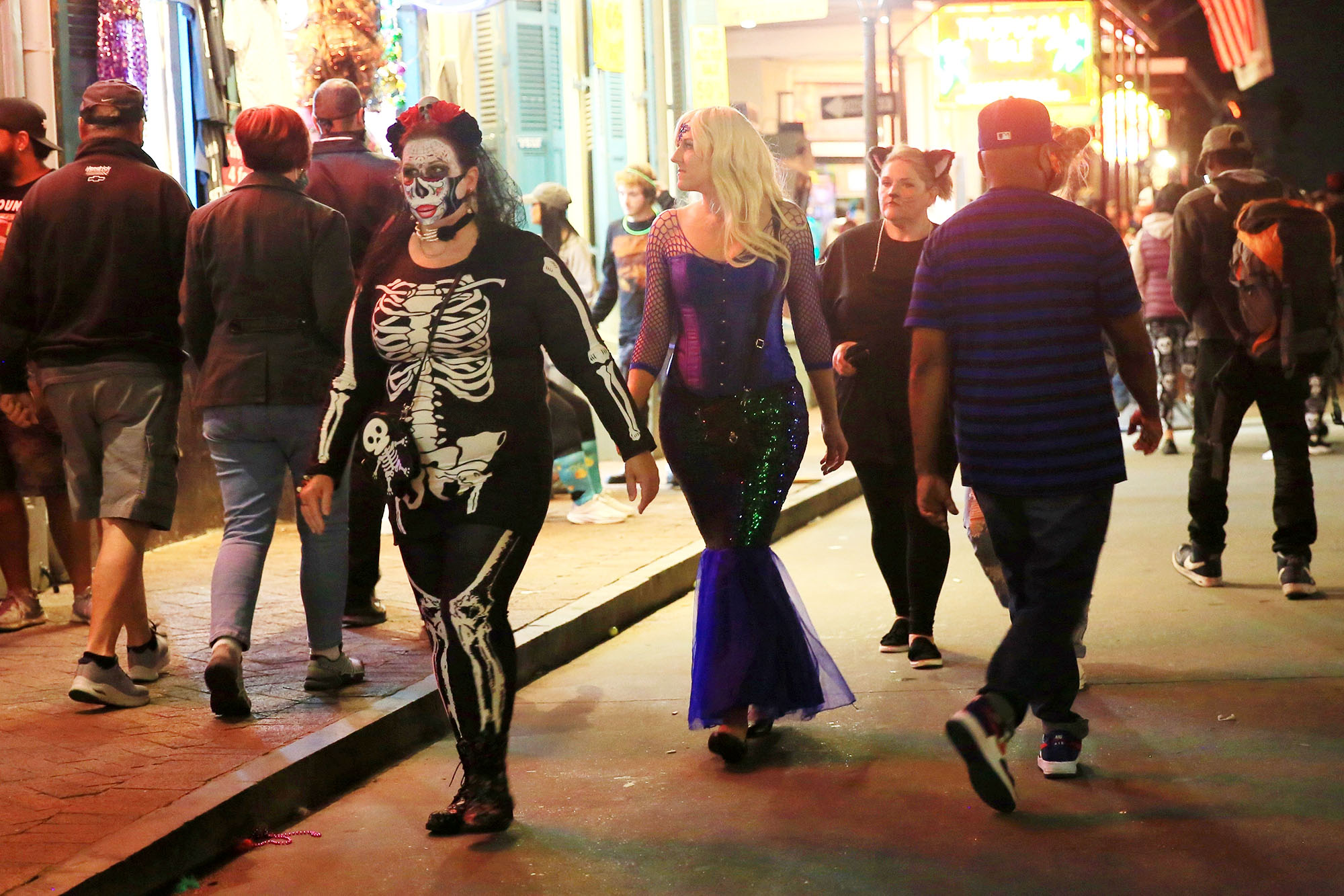 PHOTO: Bourbon Street is crowded with costumed revelers on Halloween night while public gatherings were limited and bars closed at 11pm due to COVID-19 restrictions in New Orleans, Oct. 31, 2020.
