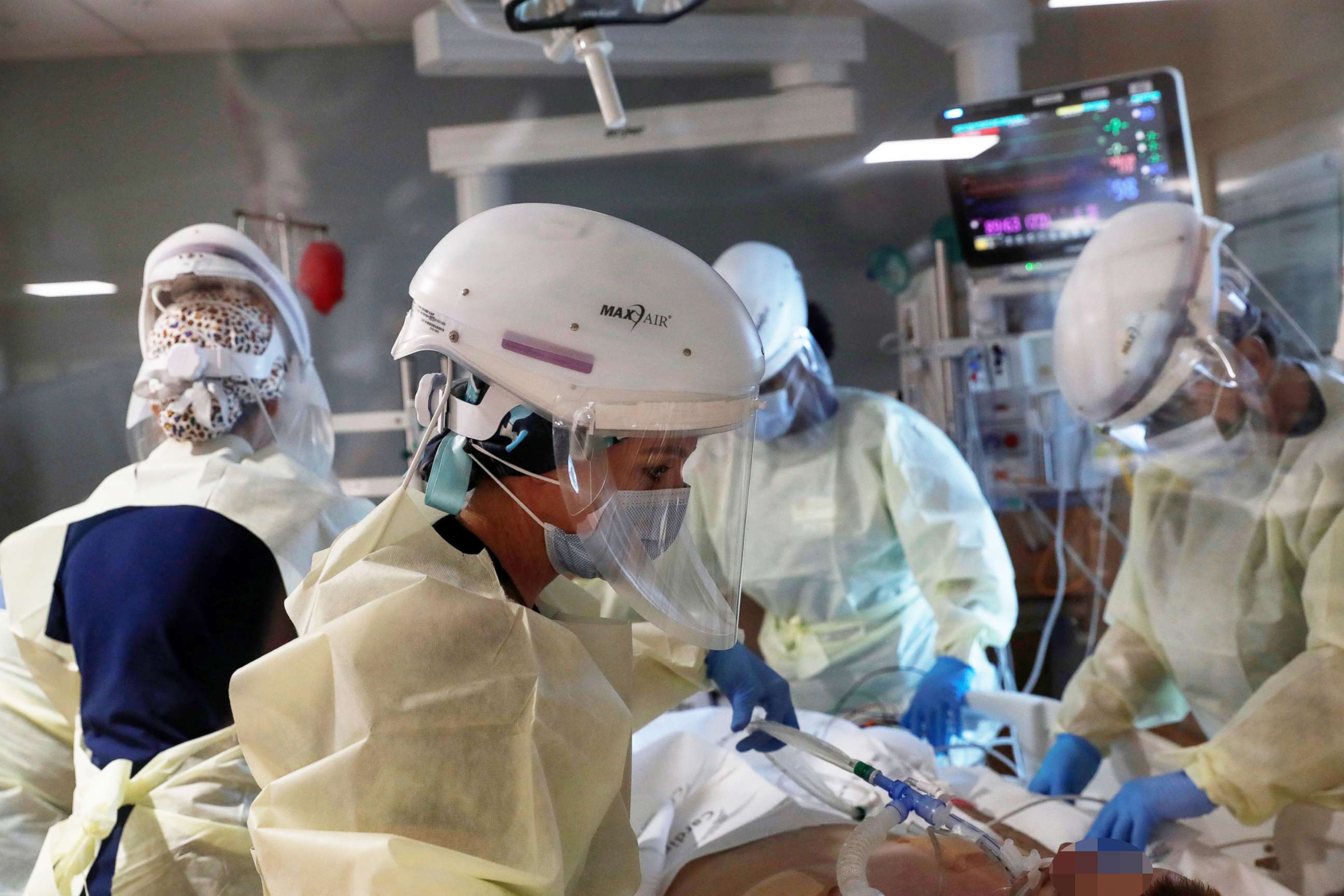 PHOTO: Members of a critical care team treat a COVID-19 positive patient inside his isolation room in the intensive care unit at Sarasota Memorial Hospital in Sarasota, Fla., Sept. 21, 2021.