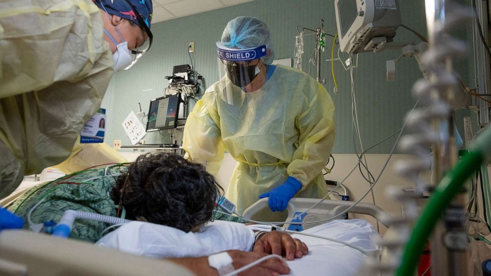 PHOTO: Health care workers check on a COVID-19 patient in the COVID ICU at St. Joseph Hospital in Orange, Calif., on July 21, 2021.