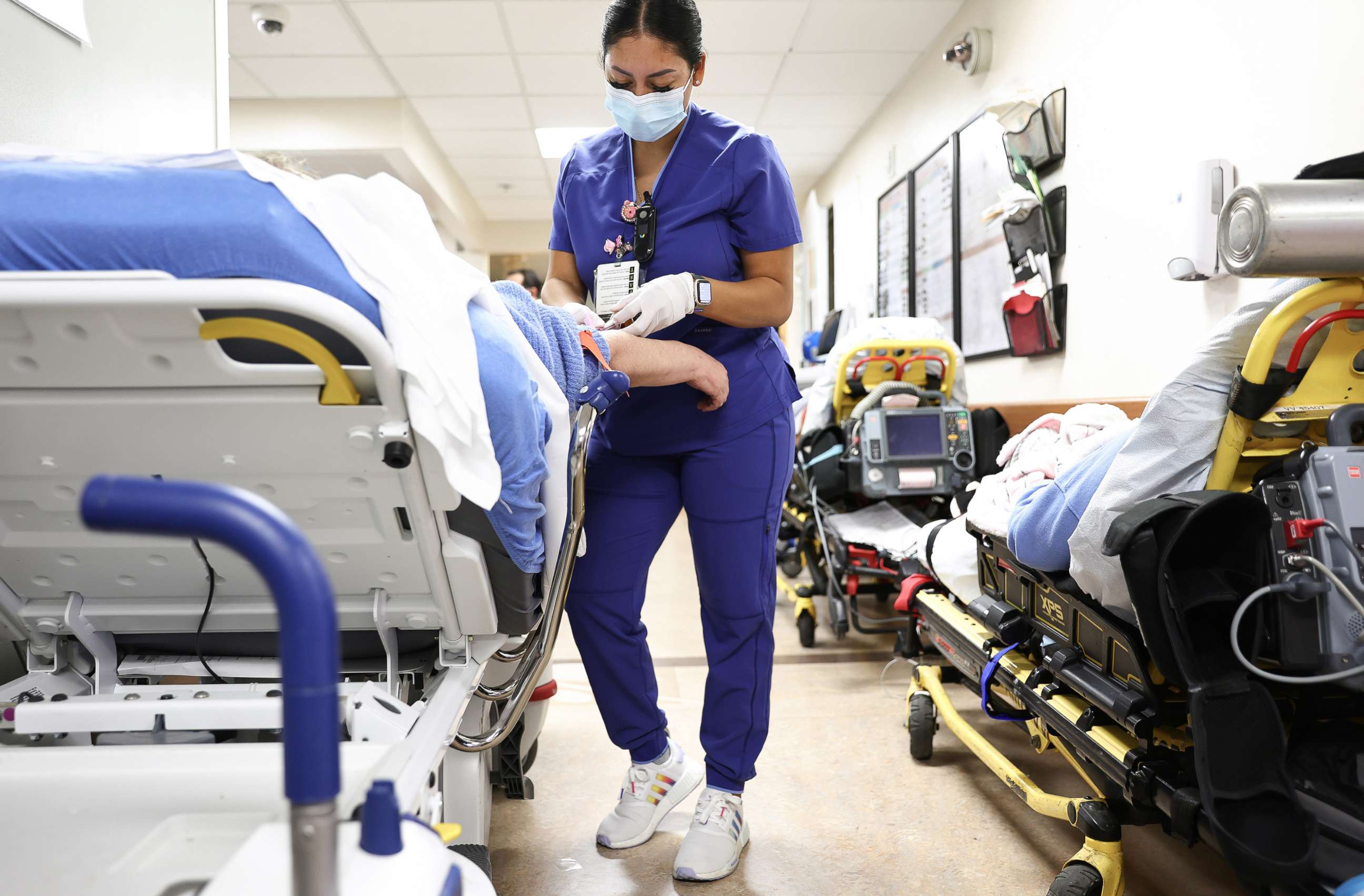 PHOTO: Lab technician Alejandra Sanchez cares for a patient in the Emergency Department at Providence St. Mary Medical Center in Apple Valley, Calif., March 11, 2022.