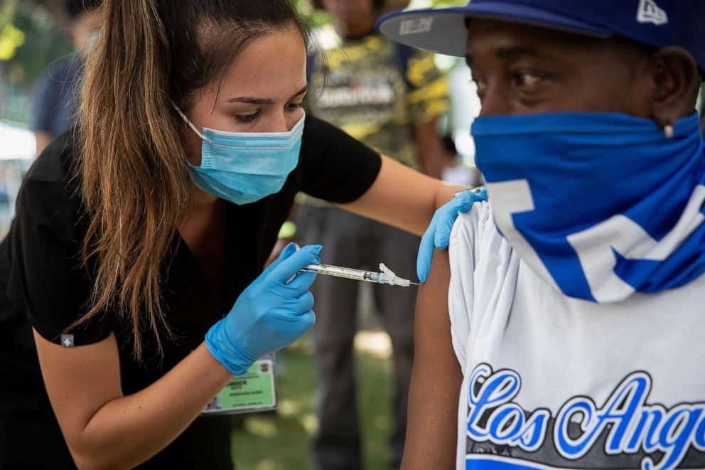 PHOTO: Healthcare worker Amber Boyd administers a COVID-19 vaccine at a clinic for individuals experiencing homelessness at San Julian Park in Los Angeles, Sept. 22,  2021.