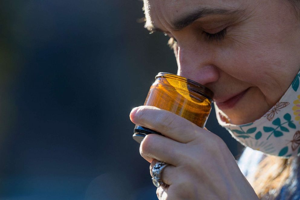 PHOTO: Food editor Leah Holzel smells aromatic spices on March 22, 2021 in New York City. Holzel, who had lost her sense of smell from 2016 to 2019, now coaches people who have lost their sense of smell due to Covid-19.