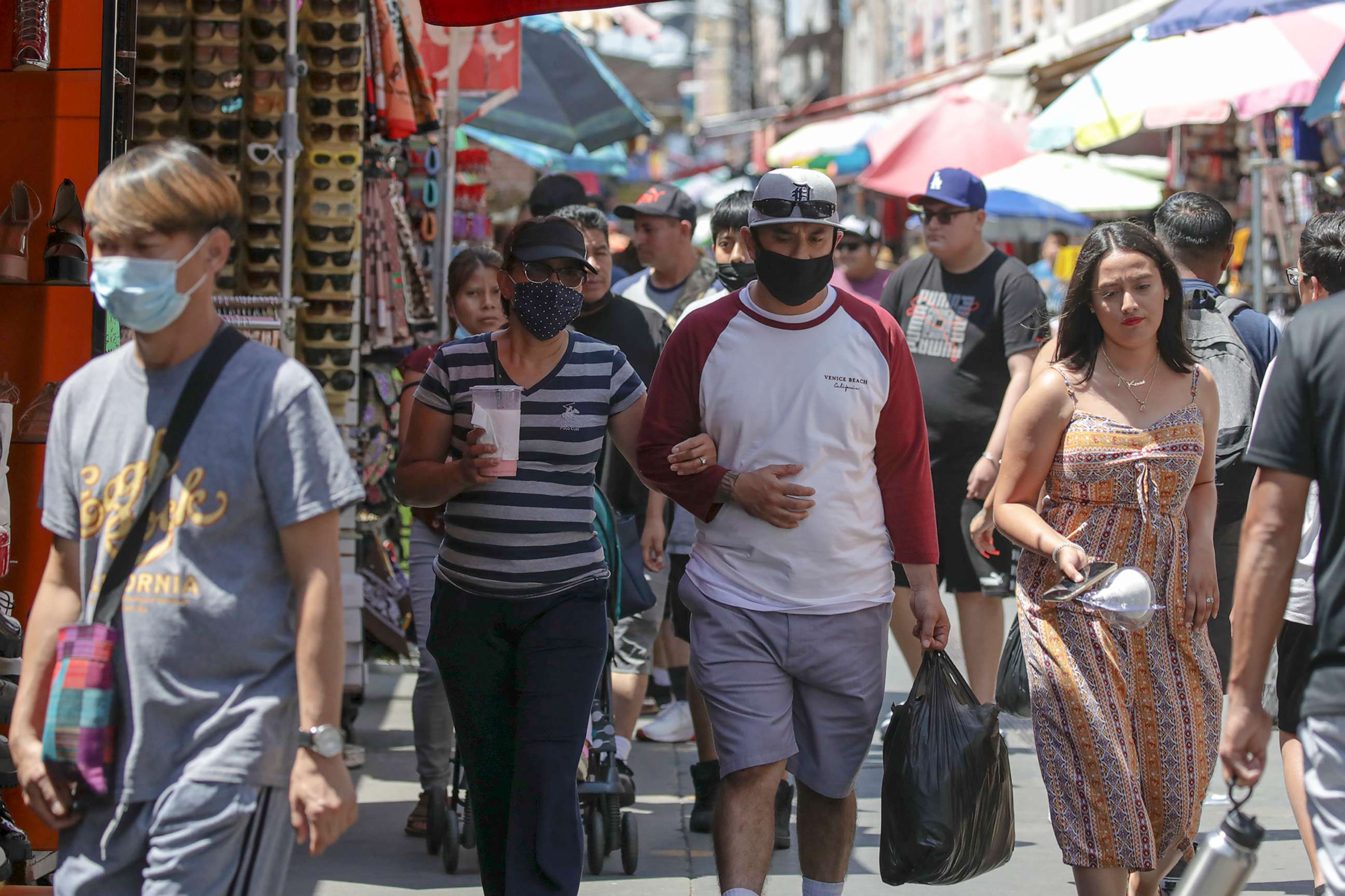 PHOTO: Shoppers, some wearing masks, visit in a market, July 14, 2022 in Los Angeles, during the COVID-19 pandemic.