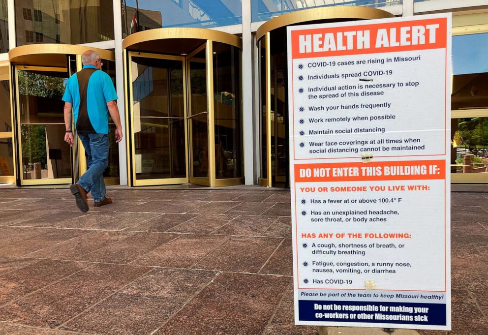 PHOTO: A sign warning of COVID-19 dangers remains in place on June 15, 2021 outside the entryway of a state office building in Jefferson City, Mo.