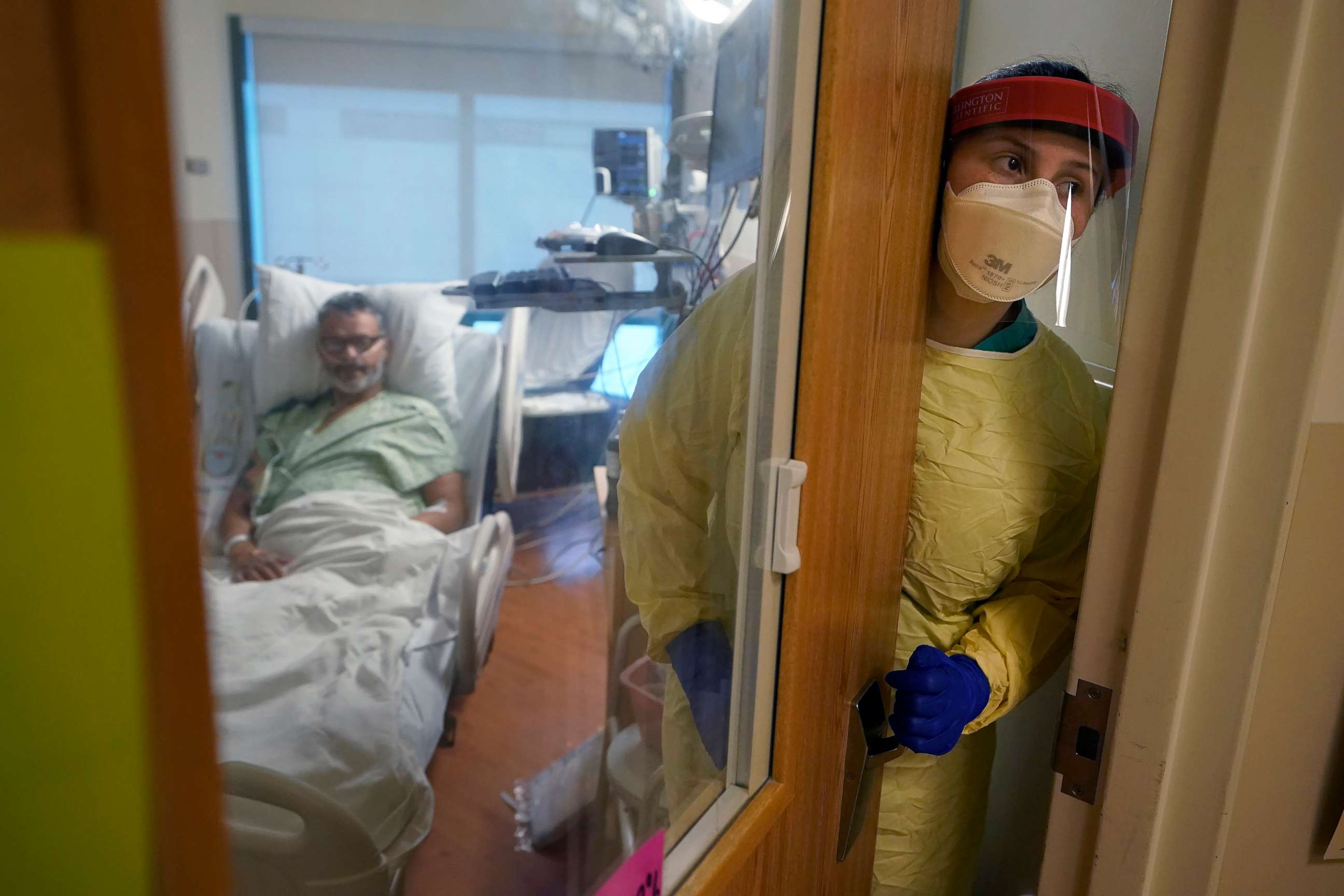 PHOTO: A registered nurse steps out of an isolation room at the Dartmouth-Hitchcock Medical Center, in Lebanon, N.H., Jan. 3, 2022.