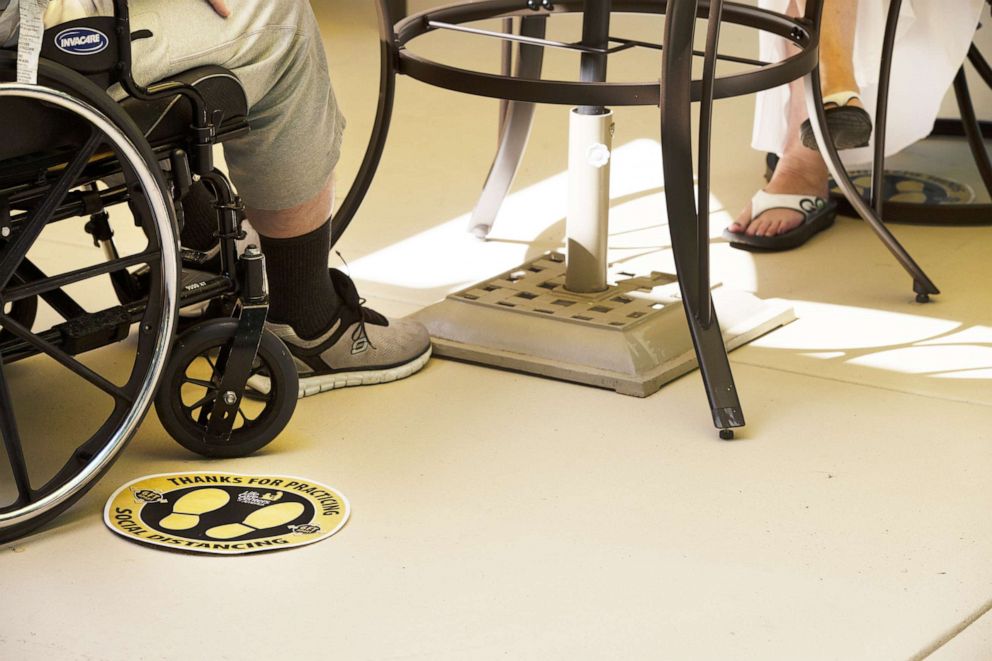 PHOTO: Social distancing reminders are seen near a table during a visit at a nursing home in Kirkland, Wash., Aug. 24, 2020.