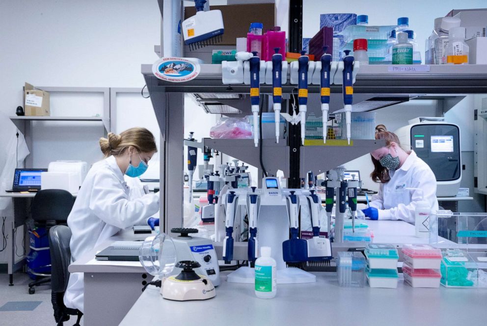 PHOTO: Amber Whitaker (l) performs genome sequencing on positive COVID-19 tests in a research lab in Flagstaff, Ariz., Oct. 4, 2021.