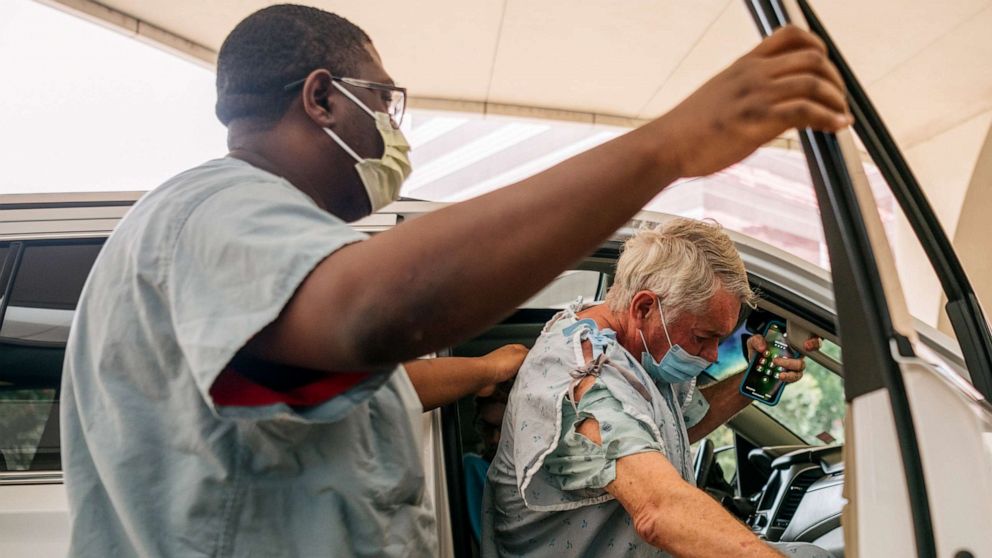 PHOTO: A patient is helped into a vehicle after leaving the Houston Methodist Hospital, July 16, 2021 in Houston, Texas.