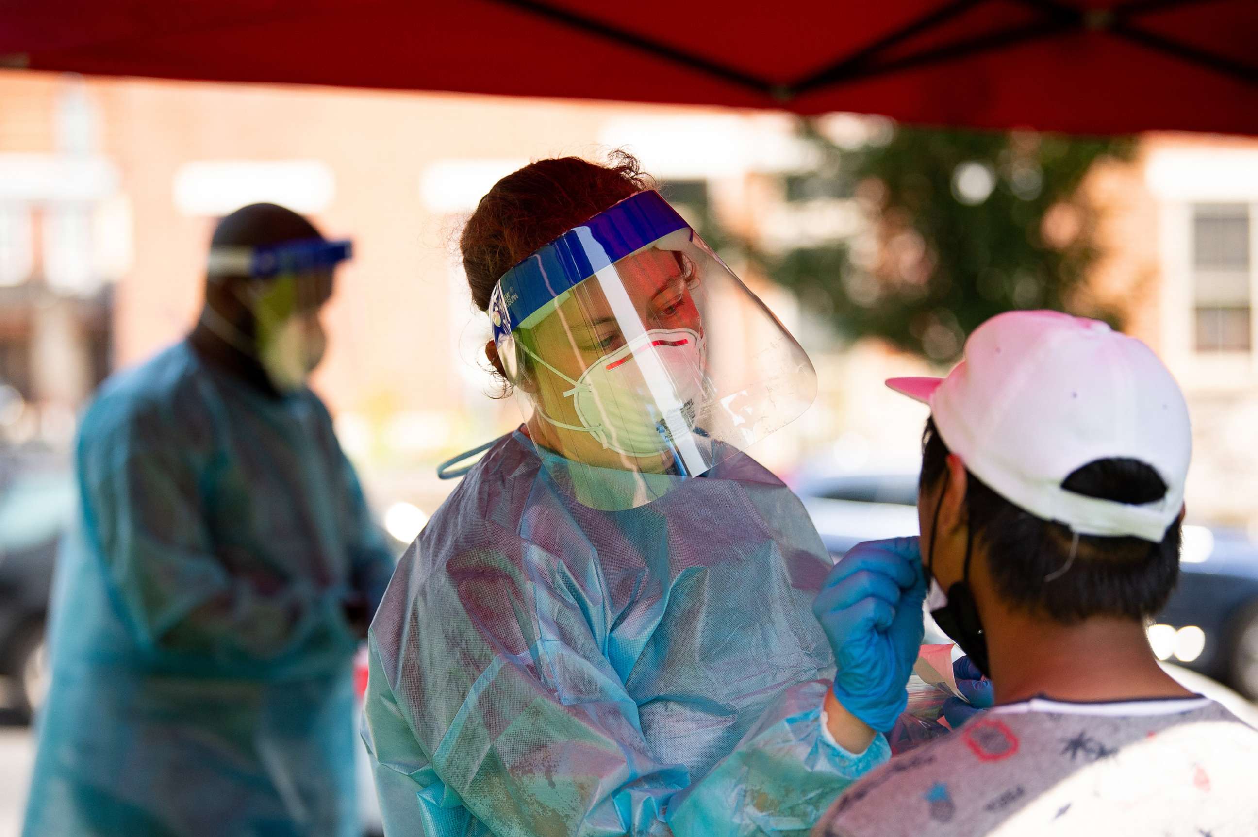 PHOTO: A healthcare worker administers a Covid-19 test at a testing site in Mifflin Square Park in Philadelphia, Aug. 12, 2021.