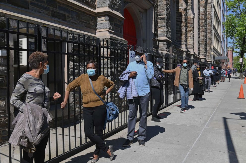 PHOTO: Residents wait in line to get tested for COVID-19 antibodies in the Harlem neighborhood of New York, May 14, 2020.