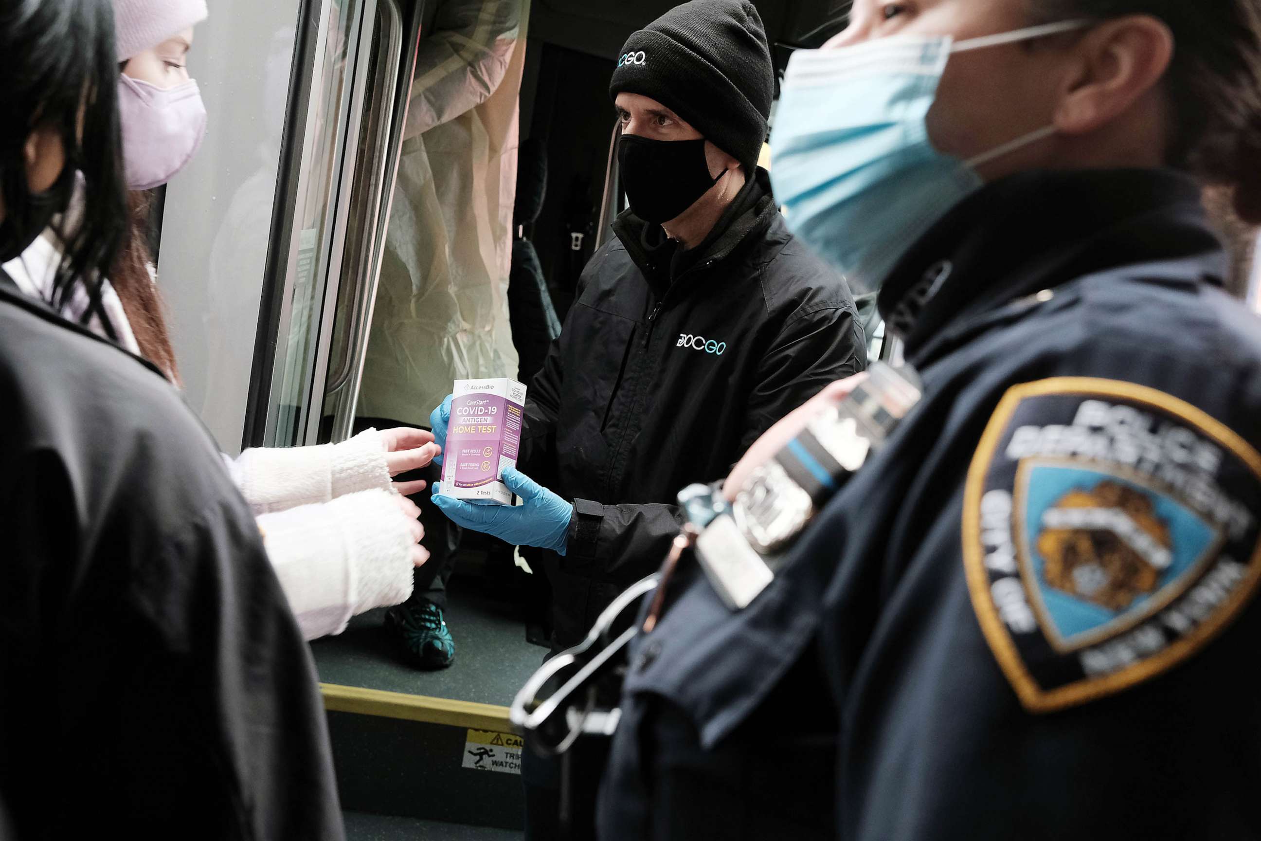 PHOTO: FILE - Police assist as a large crowd attempts to receive COVID-19 testing kits from city workers distributing the kits along Flatbush Avenue. Dec. 24, 2021 in the Brooklyn borough of New York City.