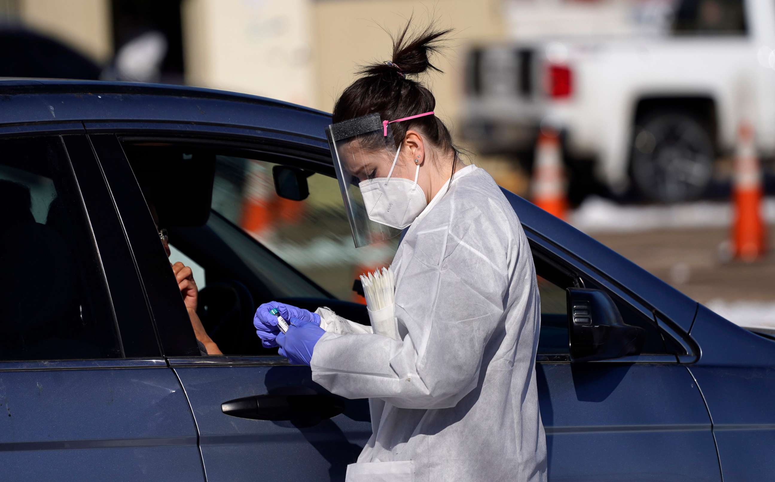 PHOTO: A tester prepares to administer a swab test at a drive-in COVID-19 testing site, Oct. 27, 2020, in Federal Heights, Colo.