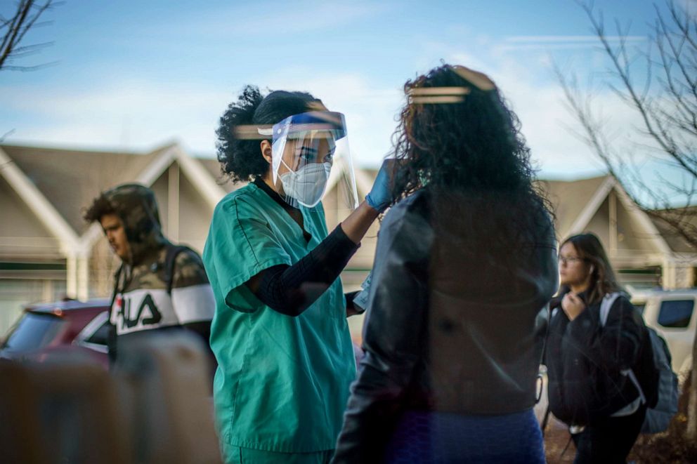 PHOTO: Maya Goode, a COVID-19 technician, performs a test on Jessica Sanchez outside Asthenis Pharmacy in Providence, R.I., Dec. 7, 2021.