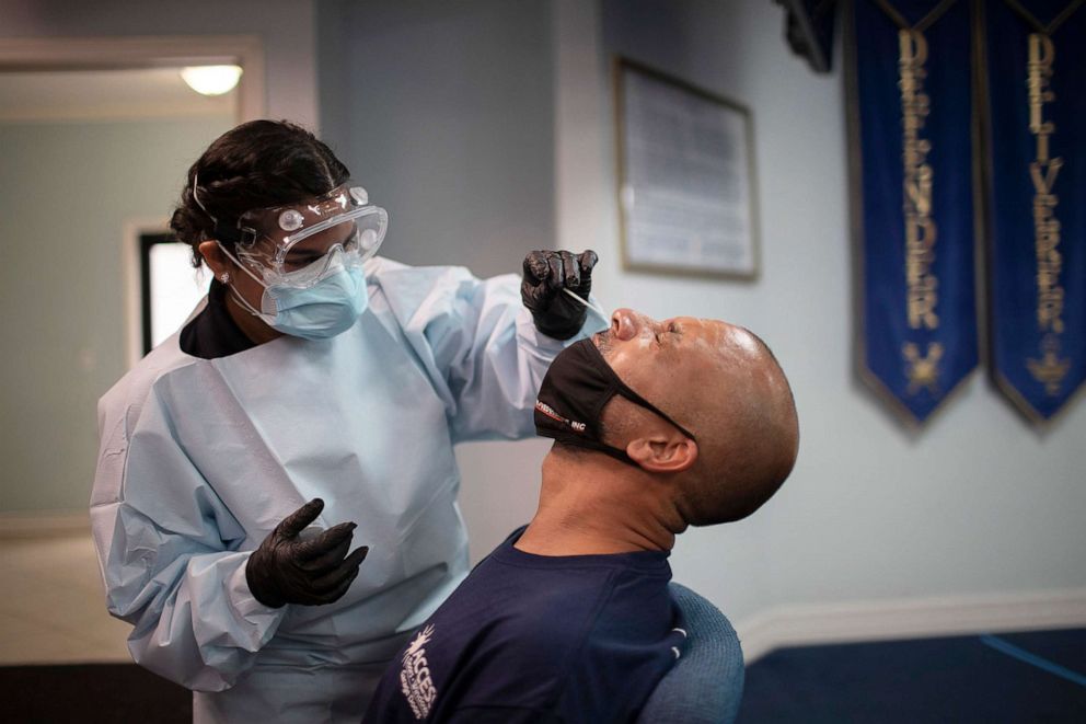 PHOTO: A health care worker use a nasal swab to test Eric Rodriguez for COVID-19 at the Koinonia Worship Center and Village, July 22, 2020, in Pembroke Park, Fla. 