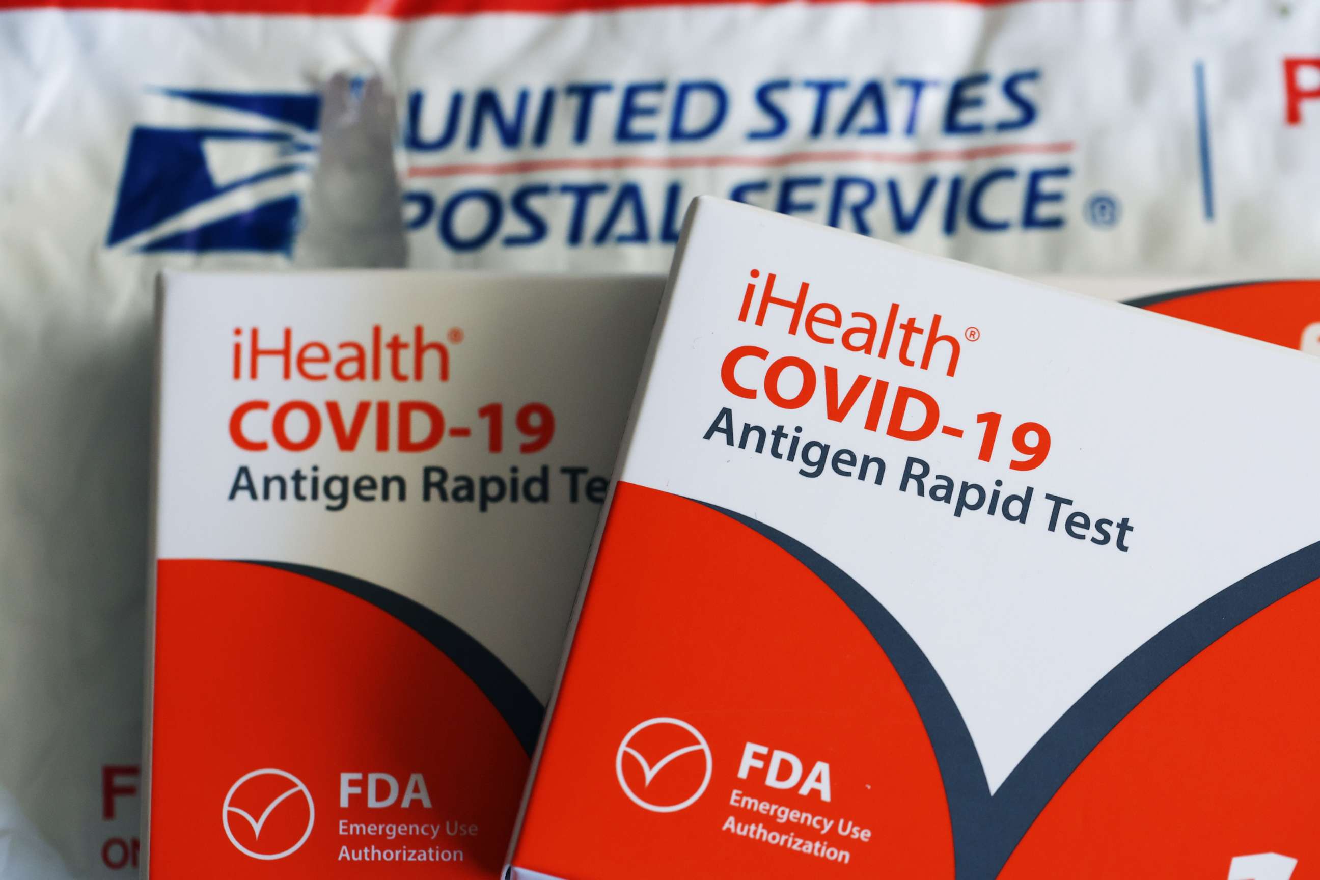 PHOTO: Free iHealth COVID-19 antigen rapid tests from the federal government sit on a U.S. Postal Service envelope after being delivered on Feb. 04, 2022 in San Anselmo, Calif.