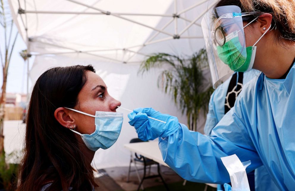 PHOTO: A registered nurse administers a COVID-19 test to a person at Sameday Testing on July 14, 2021, in Los Angeles.