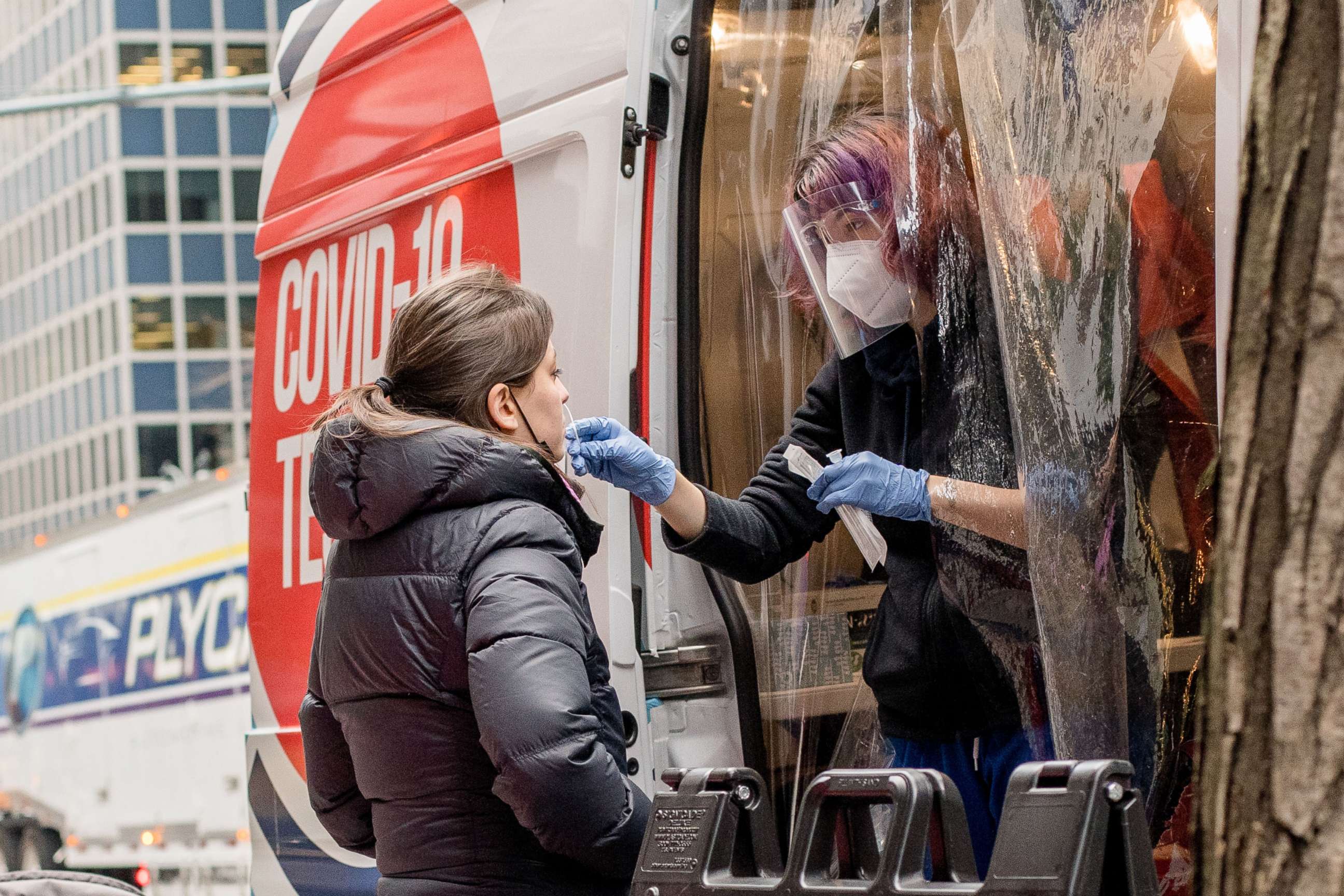 PHOTO: A health worker collects a swab sample from a person for COVID-19 testing at a mobile COVID-19 testing site in New York, Dec. 27, 2021.