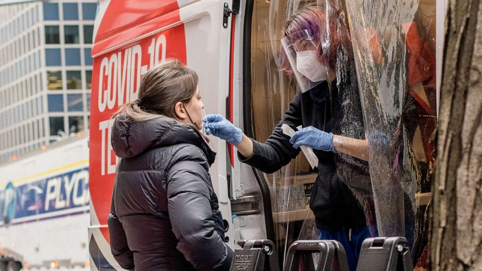 PHOTO: A health worker collects a swab sample from a person for COVID-19 testing at a mobile COVID-19 testing site in New York, Dec. 27, 2021.
