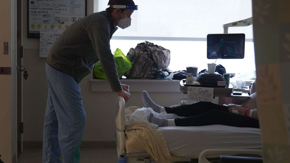 PHOTO: A doctor speaks with an unvaccinated Covid-19 patient on the Intensive Care Unit floor at Hartford Hospital in Hartford, Conn., Feb. 1, 2022.