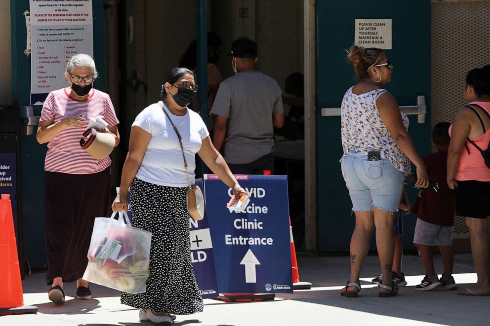 PHOTO: In this Aug. 5, 2022, file photo, people wearing face masks are seen at a COVID-19 vaccine clinic in Los Angeles.