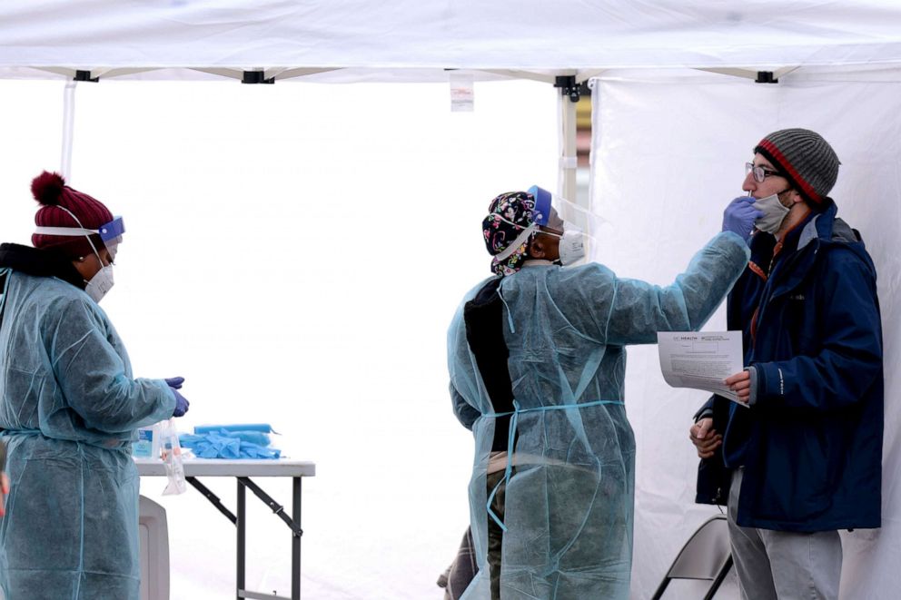 PHOTO: Healthcare workers administer COVID-19 PCR test at a free test site in Farragut Square on Dec. 28, 2021, in Washington, D.C.