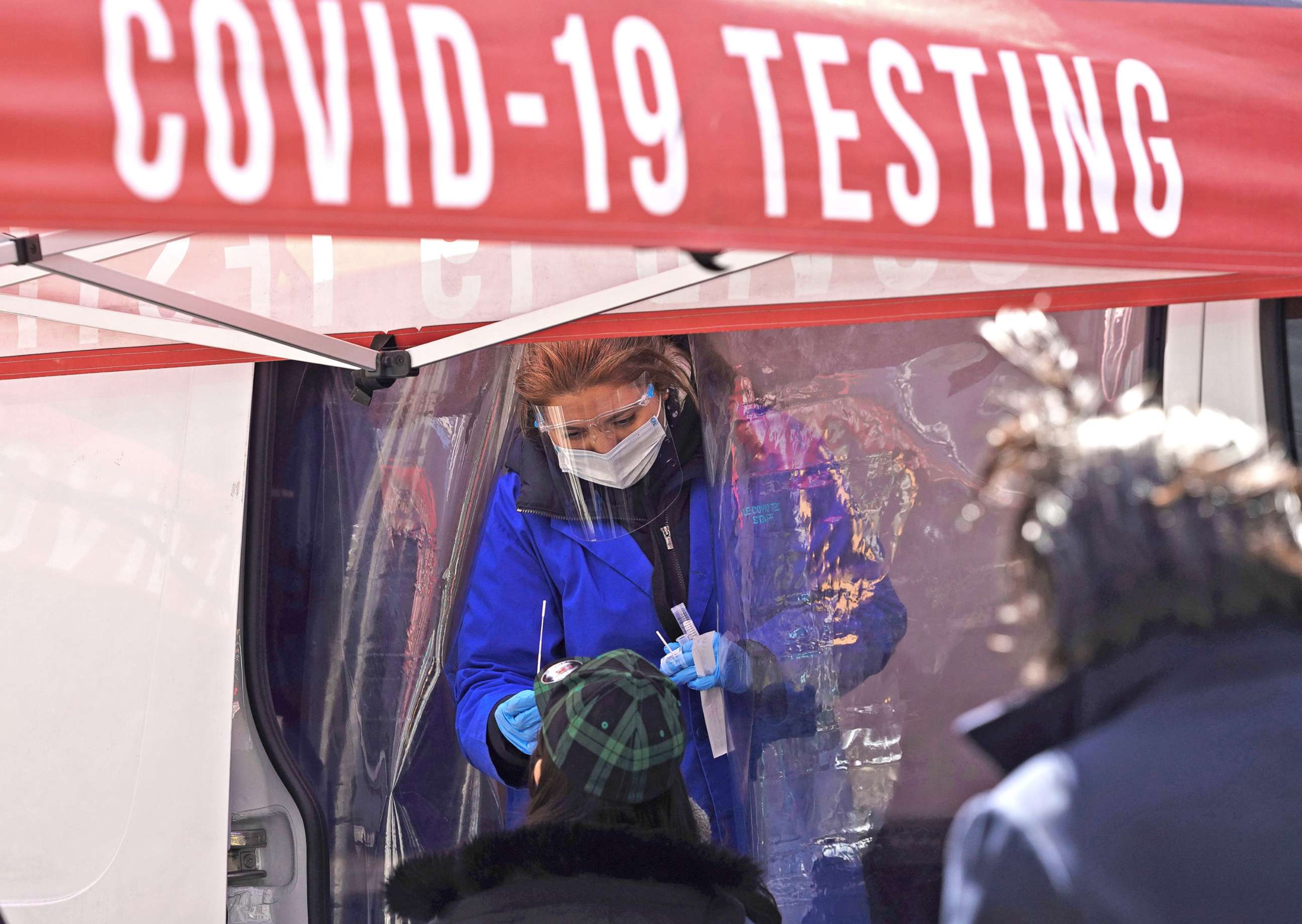 PHOTO: A medical worker collects a swab sample from a person at a COVID-19 testing site on Times Square in New York, March 29, 2022.