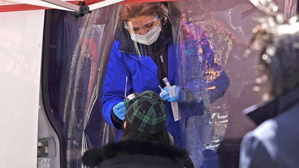 PHOTO: A medical worker collects a swab sample from a person at a COVID-19 testing site on Times Square in New York, March 29, 2022.