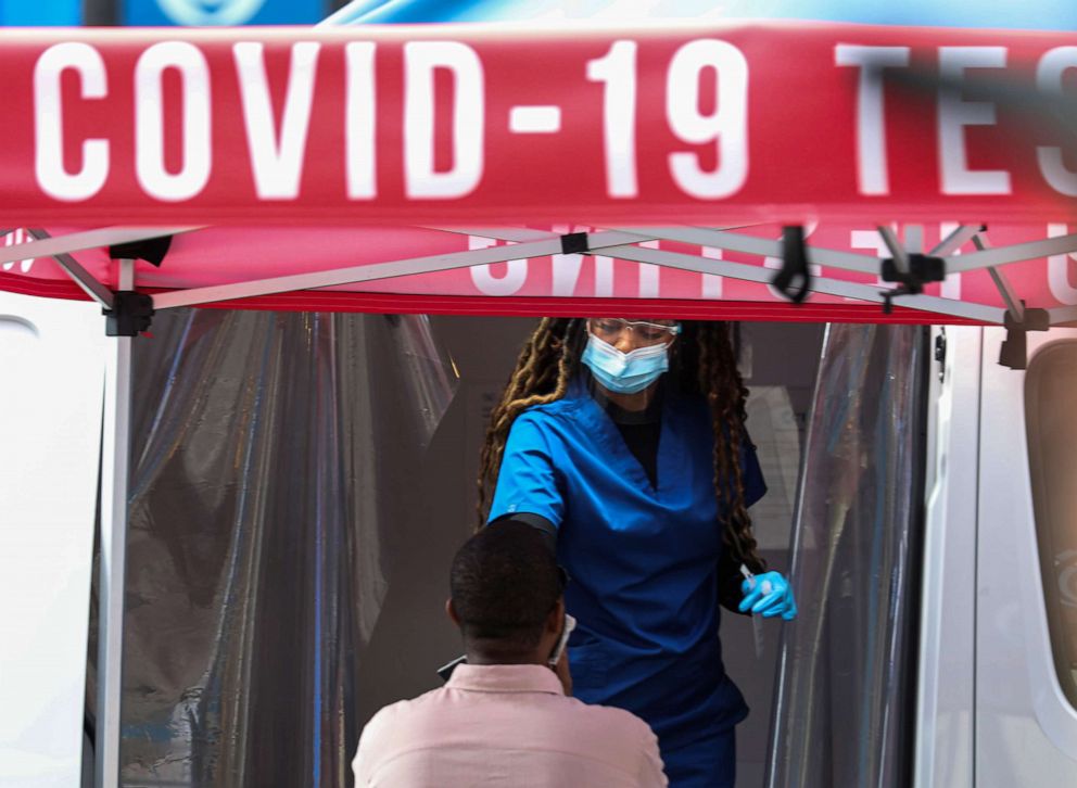 PHOTO: A medical worker collects a swab sample from a man at a COVID-19 testing site on Times Square in New York, May 17, 2022.