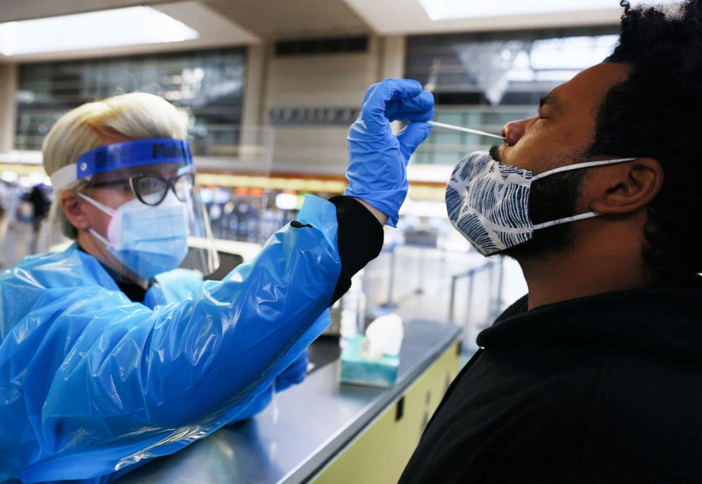 PHOTO: A man receives a nasal swab COVID-19 test at Tom Bradley International Terminal at Los Angeles International Airport (LAX) amid a coronavirus surge in Southern California, Dec. 22, 2020, in Los Angeles.