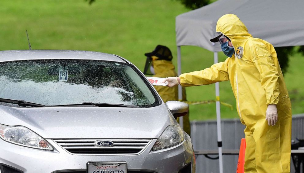 PHOTO: A driver receives a COVID-19 test kit at a coronavirus mobile testing site at Lincoln Park in Los Angeles, Calif., on April 10, 2020 as COVID-19 antibody testing begins at locations across Los Angeles County.