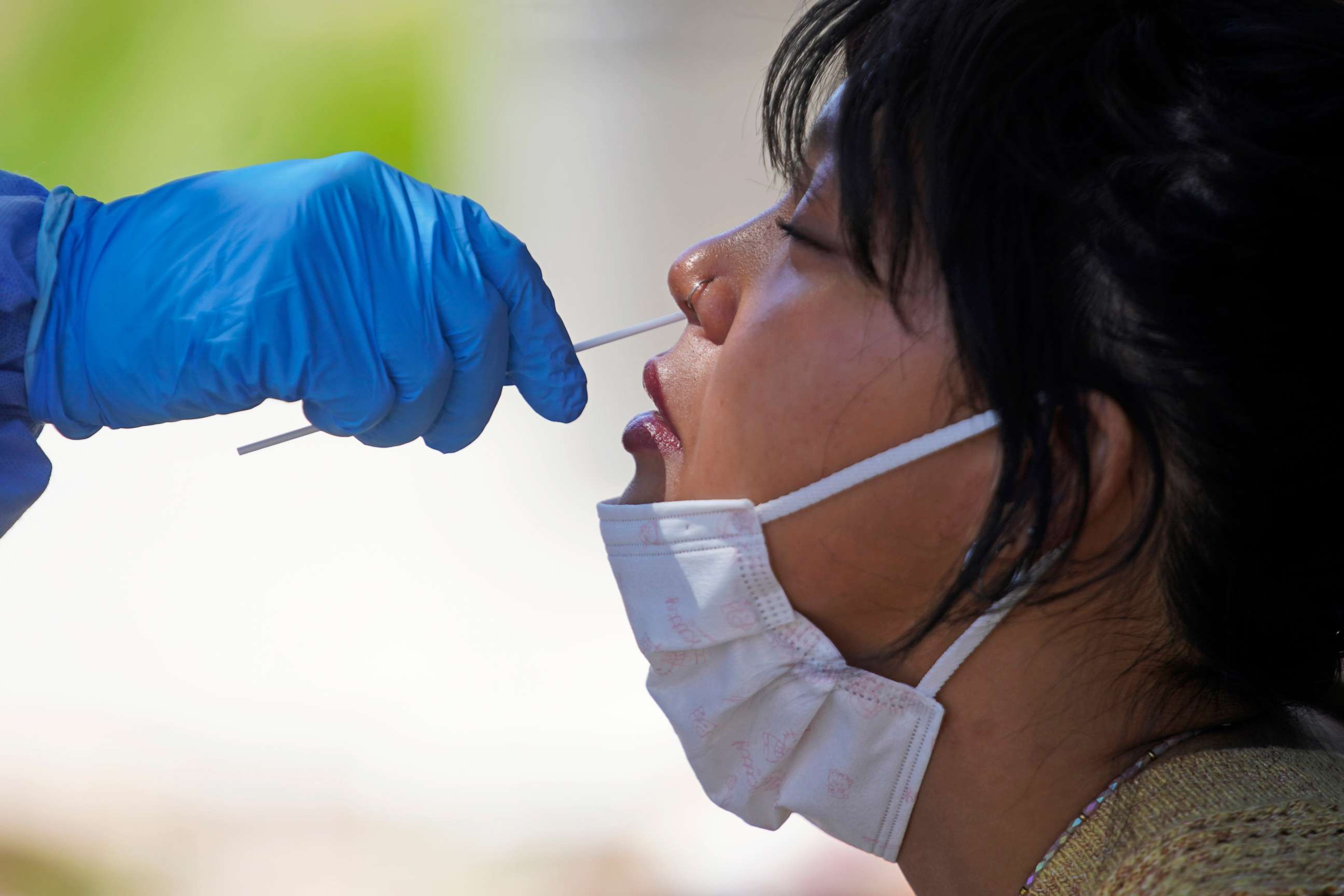 PHOTO: Delina Vongsady receives a COVID-19 test outside the Salt Lake County Health Department, June 21, 2022, in Salt Lake City.