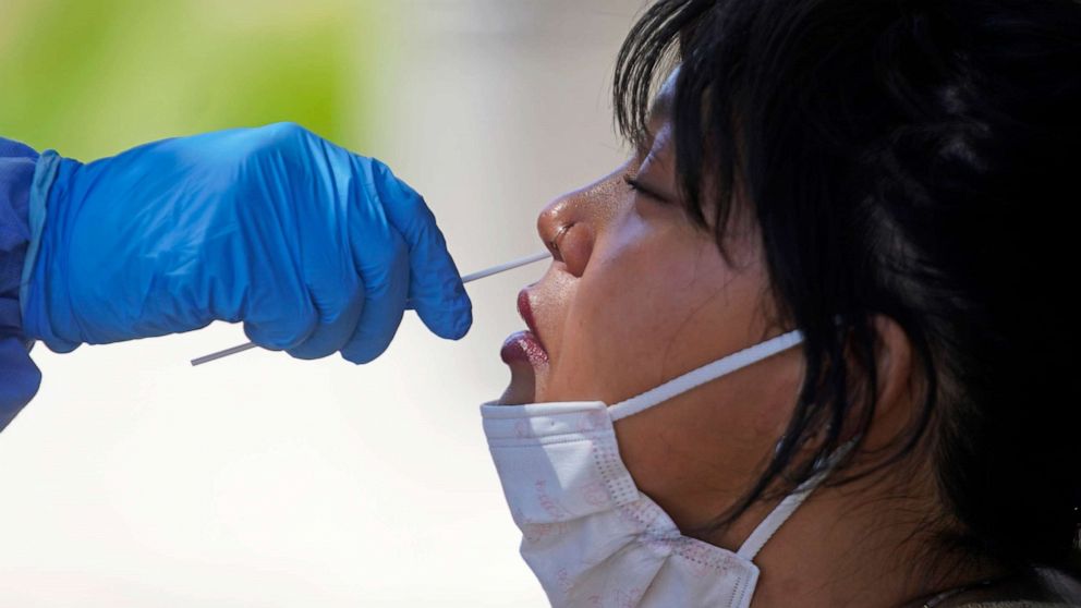 PHOTO: Delina Vongsady receives a COVID-19 test outside the Salt Lake County Health Department, June 21, 2022, in Salt Lake City.