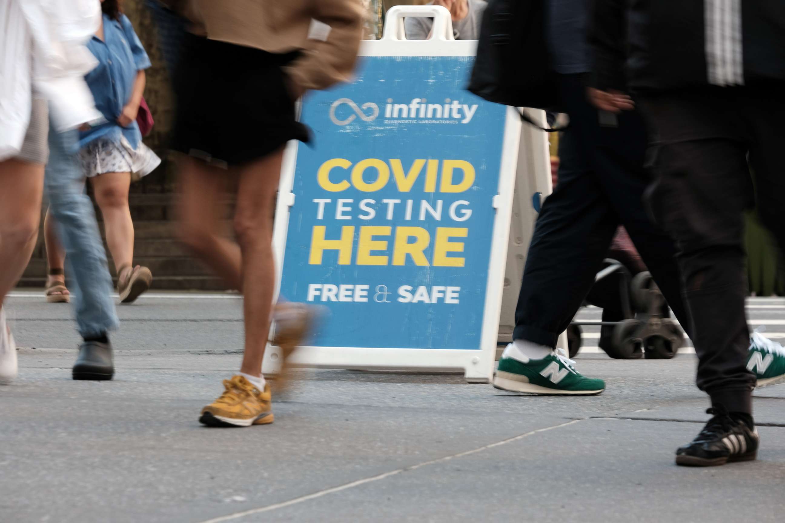 PHOTO: People walk past a Covid testing site, May 17, 2022, in New York City.