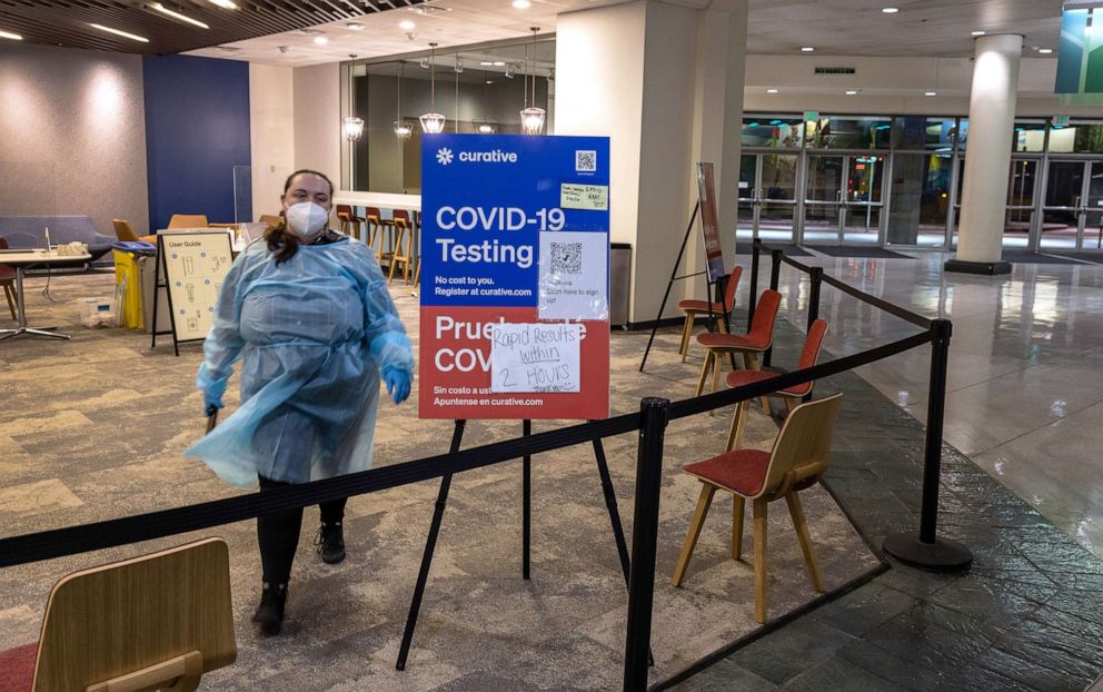 PHOTO: A health worker waits at a COVID-19 testing center at the Washington State Convention Center, March 9, 2022 in Seattle.