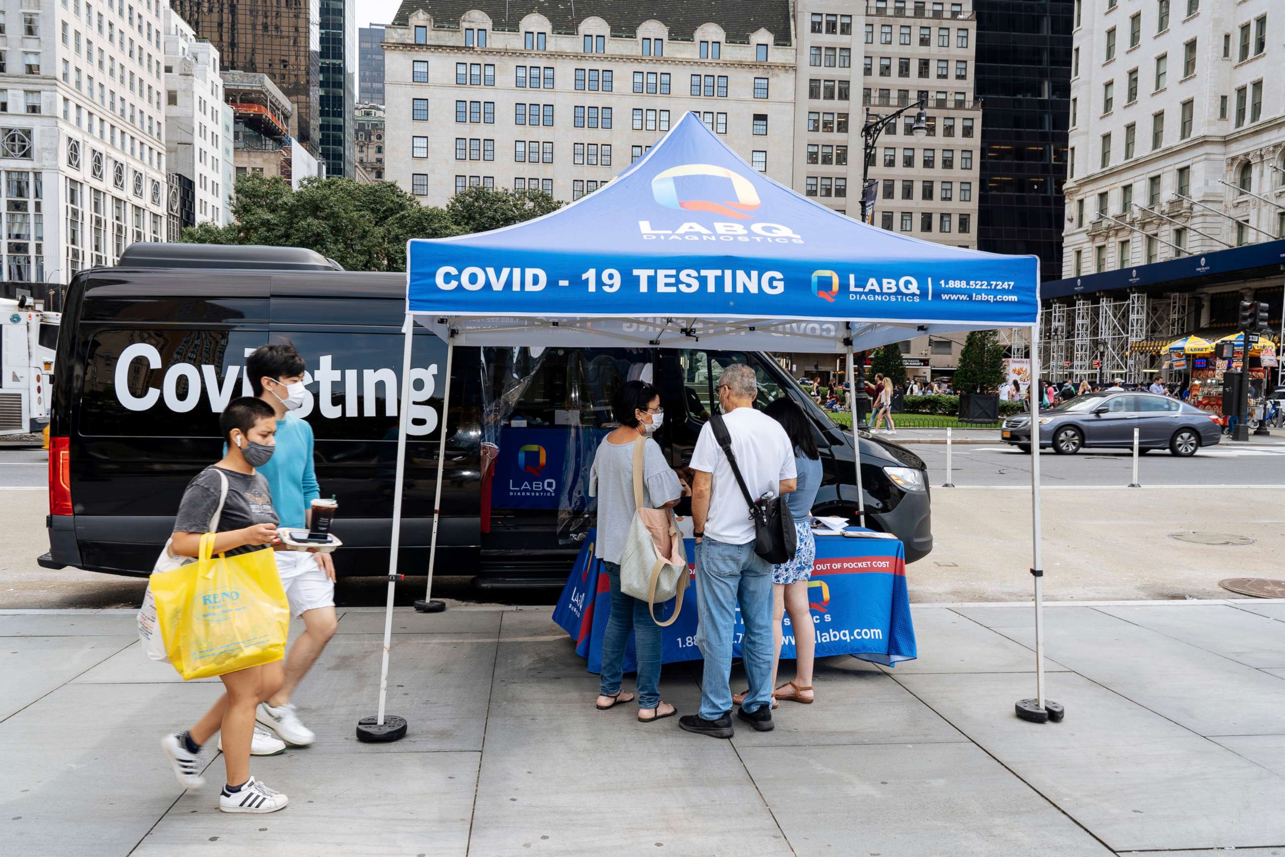 PHOTO: People stand at a mobile Covid 19 testing station at the Plaza Hotel in New York, July 11, 2021.