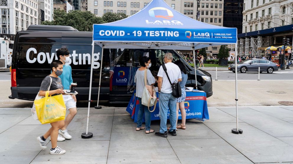 PHOTO: People stand at a mobile Covid 19 testing station at the Plaza Hotel in New York, July 11, 2021.