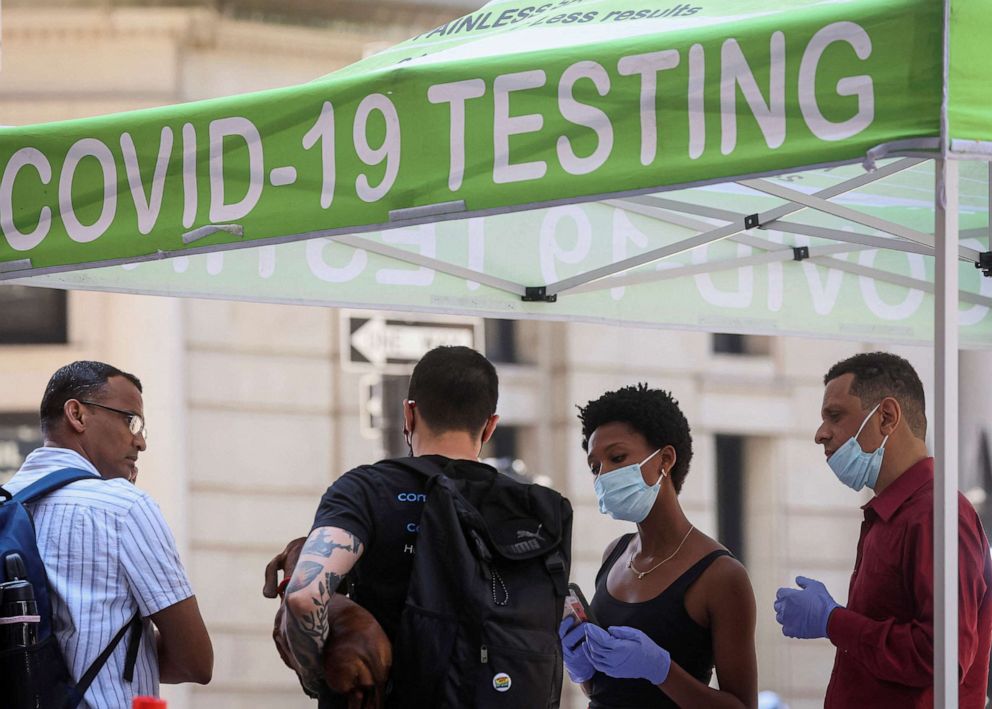 PHOTO: In this July 11, 2022, file photo, people wait to take COVID-19 tests at a pop-up testing site in New York. 