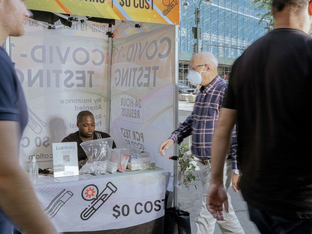 PHOTO: People walk past a mobile COVID-19 testing site in New York City, May 22, 2022.