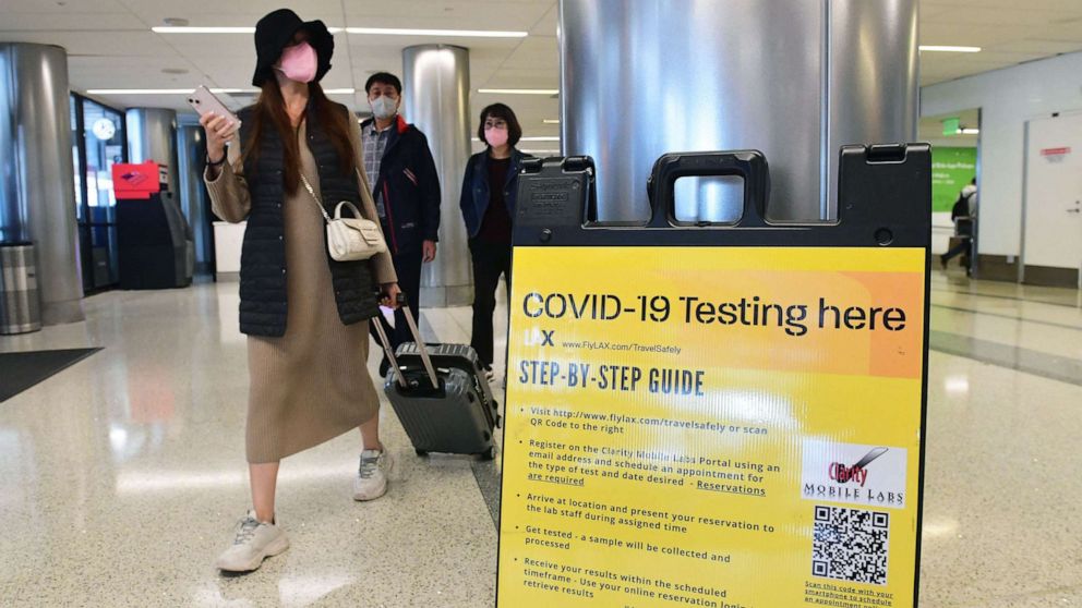 PHOTO: Travellers with their luggage arrive at Covid-19 Testing location at the airport in Los Angeles on Nov. 23, 2021, where up to two million people are expected to travel over the Thanksgiving Day holidays.