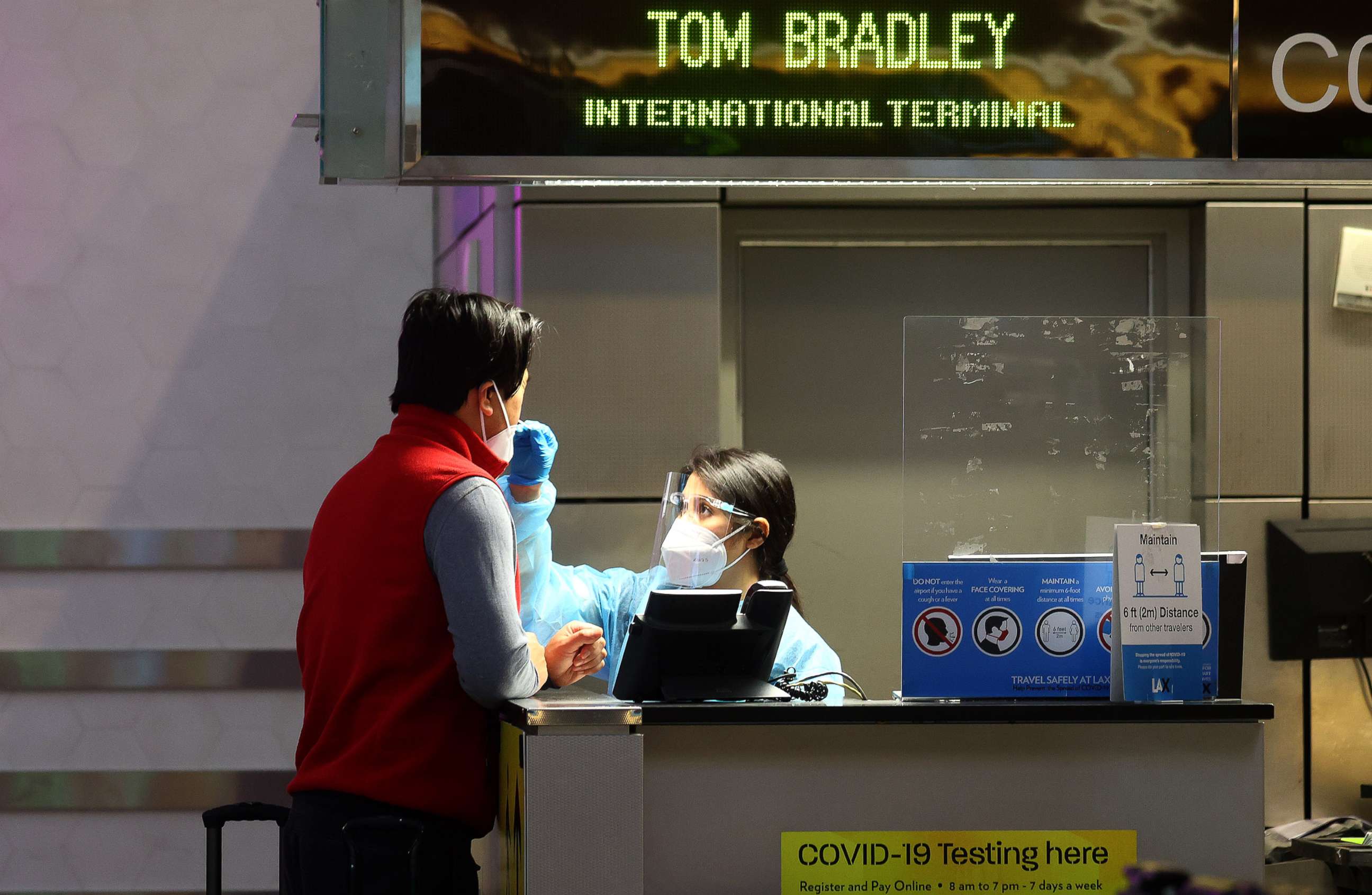 PHOTO: A person is tested for COVID-19 at a test center operating at the Tom Bradley International Terminal of the Los Angeles International Airport, on Dec. 1, 2021 in Los Angeles.