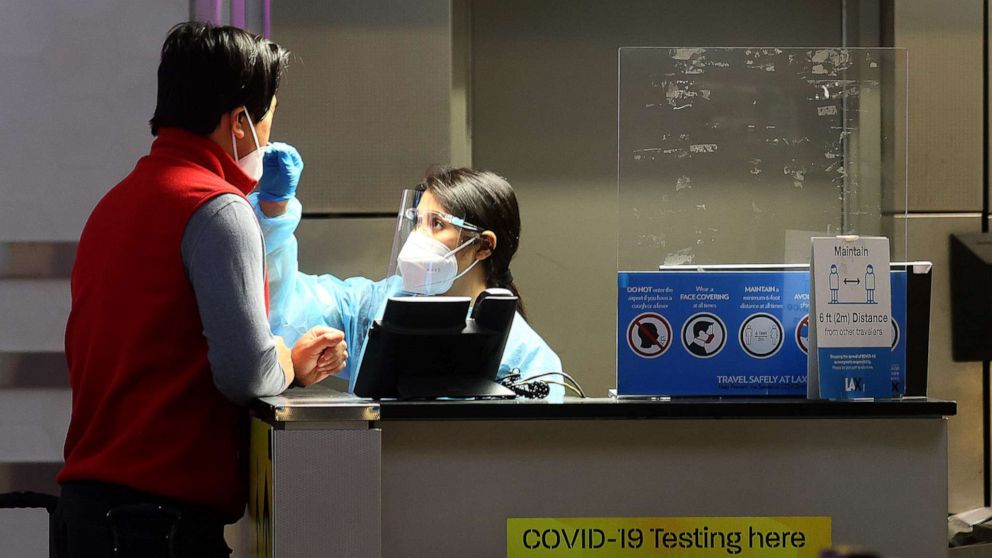PHOTO: A person is tested for COVID-19 at a test center operating at the Tom Bradley International Terminal of the Los Angeles International Airport, on Dec. 1, 2021 in Los Angeles.