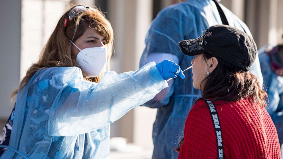 PHOTO: A fan is swabbed at the COVID-19 testing site prior to attending the opening night game of the Tomlin UNITED Tour on March 29, 2022 in San Diego, Calif.